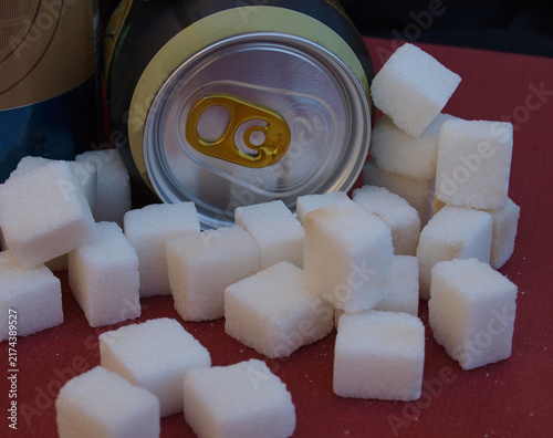 Soda can with excessive sugar cubes depicting high sugar content
