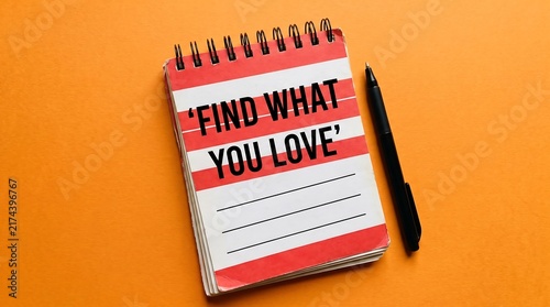 Inspirational quote notepad on orange background, Find What You Love text on spiral notebook, creative career and passion concept