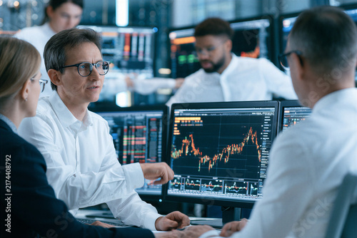 Fintech team analyzing financial data and digital analytics