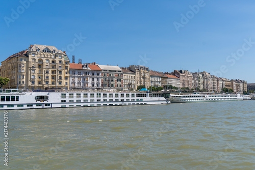 Historic houses in downtown Budapest on the Danube bank with river cruises