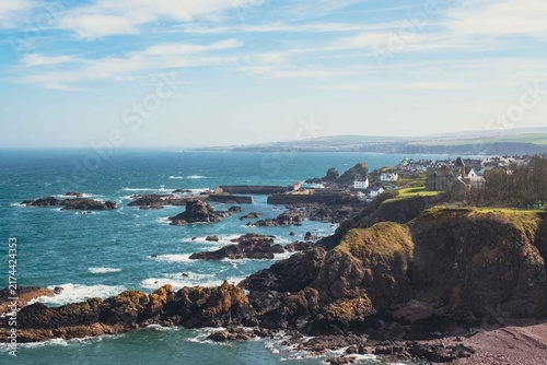 Obraz na płótnie A striking view of the historic fishing village of St Abbs, nestled among rollin