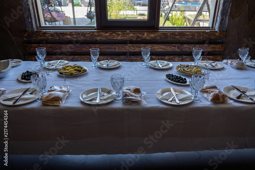 Elegant Dining Table Set with Traditional Appetizers and Olives in Restaurant.