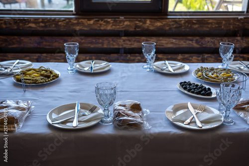 Elegant Dining Table Set with Traditional Appetizers and Olives in Restaurant.