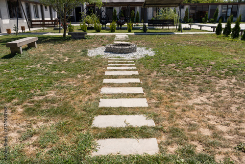 Modern Resort Courtyard with Stone Pathway and Outdoor Fire Pit.