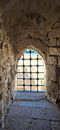 Iron bar window inside the Citadel of Qaitbay, a 15th-century defensive fortress located on the Mediterranean sea coast, on Pharos Island in Alexandria, Egypt. 