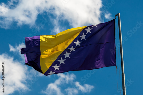 Bild auf Leinwand Bosnia and Herzegovina flag against blue sky