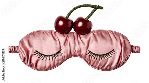 Fotografie Isolated elegant pink satin sleep mask with embroidered eyelashes and glossy red