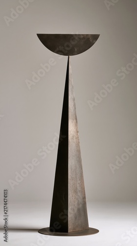 Metal sculpture showcases geometric abstract forms with a sophisticated metallic finish.