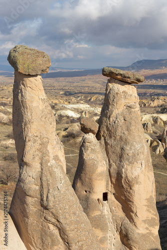 Famous fairy chimney rock pillars standing in the arid landscape of Cappadocia Central Anatolia.