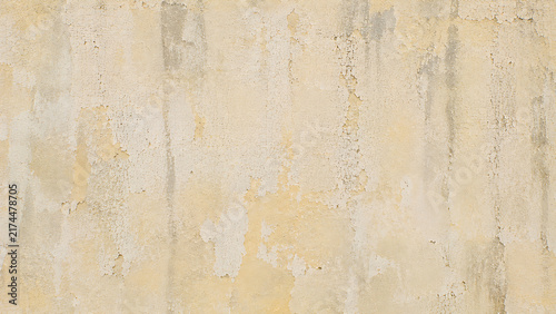 Vintage weathered concrete wall texture. Distressed beige plaster background with cracks. Grungy cement surface for architectural design.