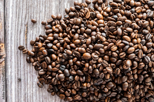 Принти на полотні Roasted coffe beans on the wood table. Drink for tasty breakfast.