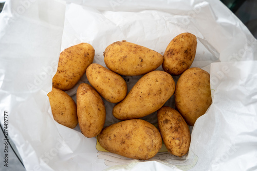 Fotografie Fresh russet potatoes in white paper bag ready for cooking or baking