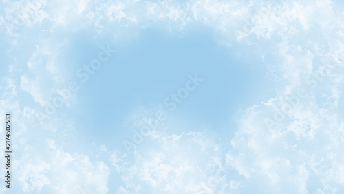 Soft Blue Sky Background Framed by Wispy White Clouds.