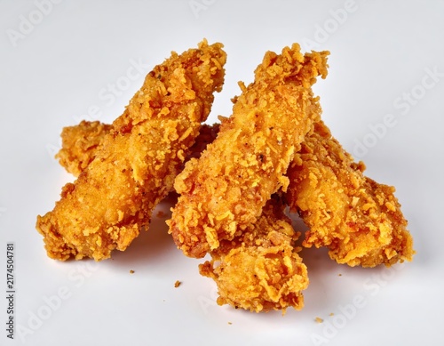 Golden crispy fried chicken strips on white background