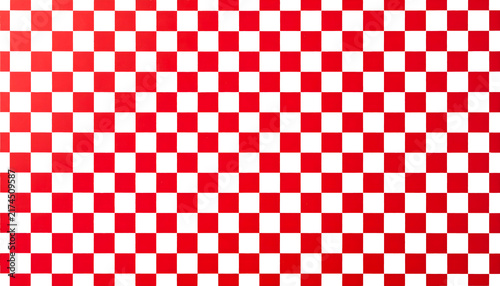 Checkerboard pattern featuring high contrast red and white squares arranged in a classic repeating grid layout design element 
