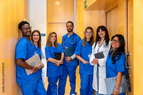 Bild auf Leinwand Diverse medical team standing in hospital hallway smiling