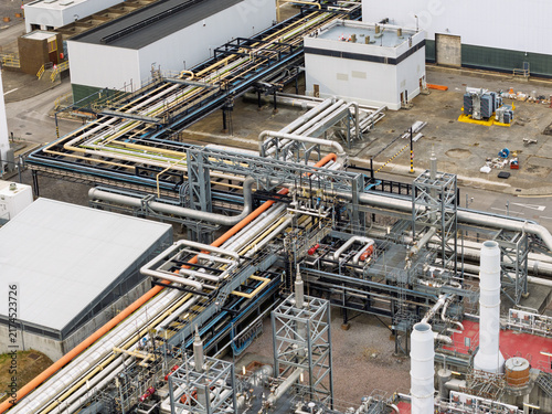 фотографія Industrial Metal Piping System at a Chemical Processing Plant During a Bright Mo