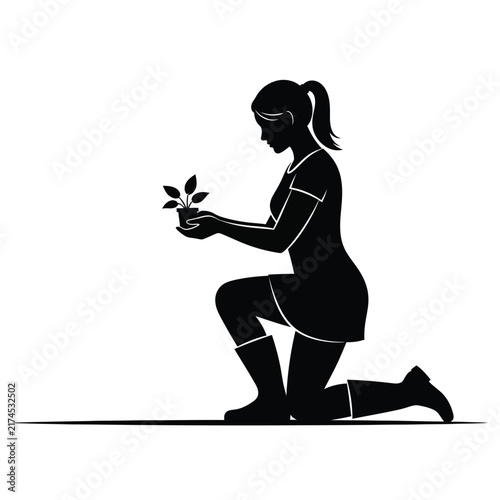 Gardener silhouette kneeling on the ground while holding a small potted plant carefully.
