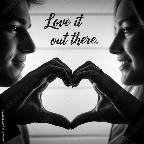 Couple forming heart shape with hands in black and white.