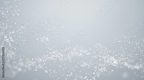 Abstract white particle wave background with glowing dots and dynamic flowing motion for futuristic design
