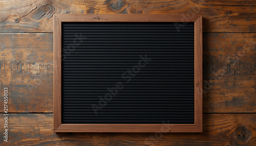 Black frame on wooden background 