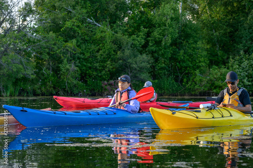 Wall Mural Two kayakers pause on a pond in the Toronto Islands during an evening group padd