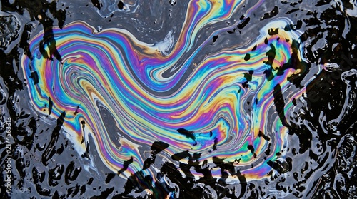 Mesmerizing Iridescent Oil Slick on Water Creating a Rainbow Spectrum of Colors, Highlighting Environmental Impact and Chemical Interaction