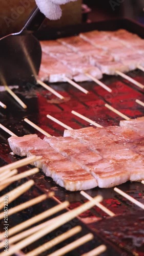 Wagyu beef skewers grilling on hot teppanyaki teppan iron plate, premium Japanese marbled meat on wooden sticks, traditional street food festival, Tokyo, Japan, market with local vendor stalls cooking