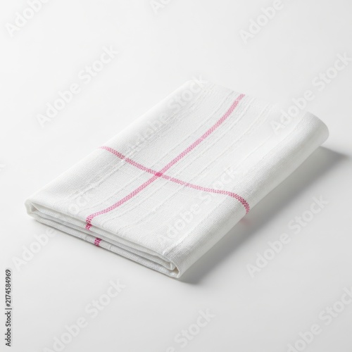 Folded white cloth napkin with red stitching detail isolated
