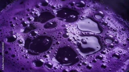 Cinematic 4K  of Spooky Bubbling Purple Potion with Screaming Skull Face Emerging from Boiling Liquid Cauldron