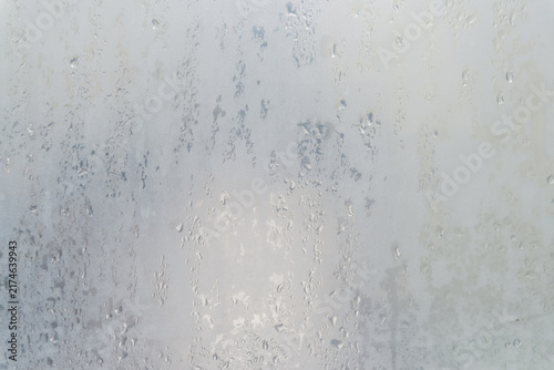 The mirror in a bathroom fogged up with water droplets during taking the shower