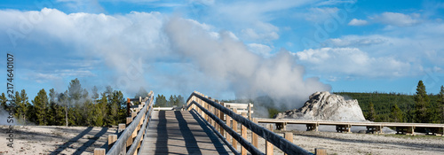Fotografie Accessible wood boardwalk to Castle Geyser in Old Faithful area of Upper Geyser