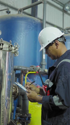 Electrical engineers are checking the maintenance systems of machinery in industrial plant. Professional engineering are taking note report data on equipment usage during work. Factory industry 