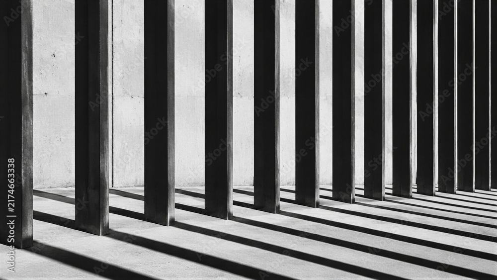 Naklejka premium Concrete columns casting long shadows in striped light
