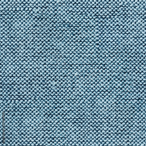 Close up view of green fabric texture with a woven pattern and small dark blue spots scattered across the surface for a modern interior design material backdrop