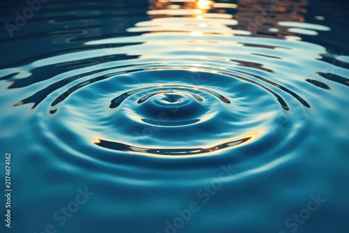 Rippling water surface, concentric circles from a central point, nature, concentric