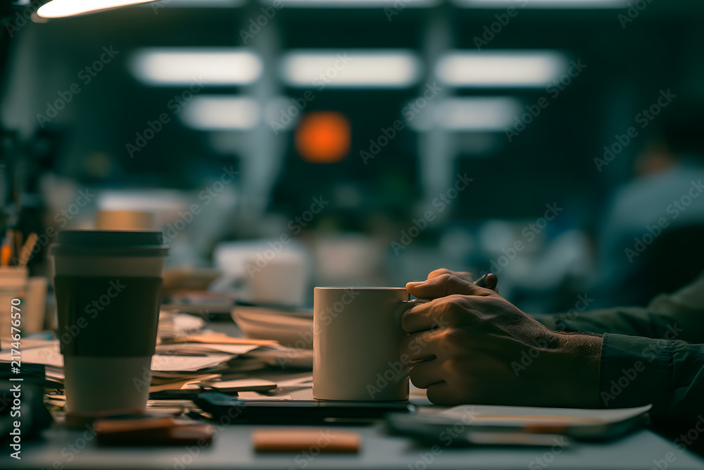 Fototapeta premium Chronic Workplace Stress with Tightly Gripped Coffee Cup at Cluttered Desk 
