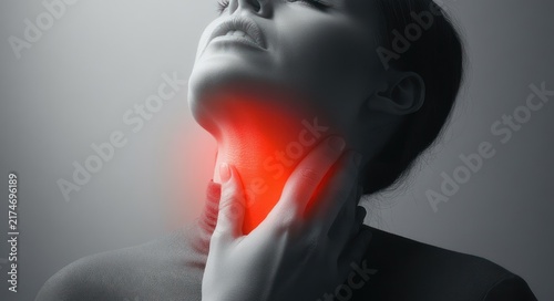 Woman clutching her throat with hand, red glowing area on neck indicating pain, expression of discomfort and strain