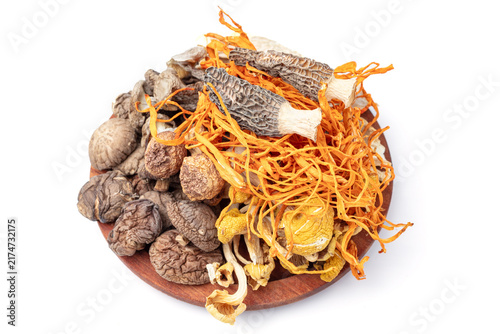 Assorted Dried Mushrooms and Cordyceps on Wooden Plate