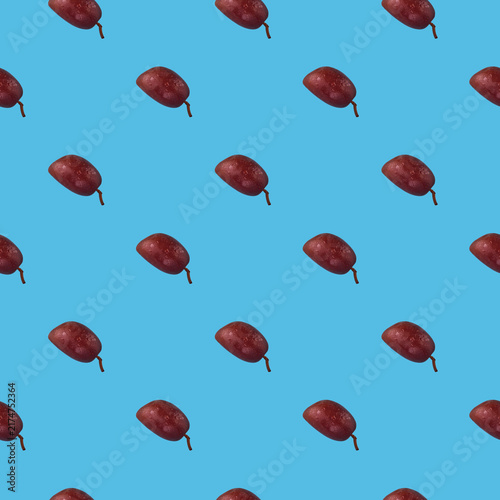 Colorful olives fruit pattern on a blue background, top view.