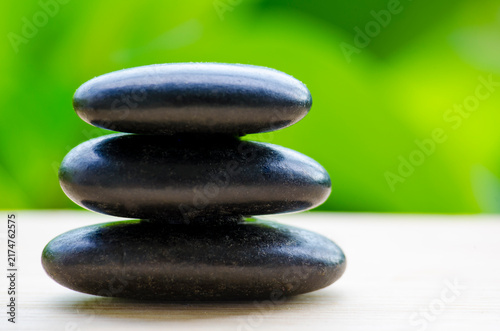 Fotografía Stacked black zen stones representing harmony and relaxation, with customizable space for text