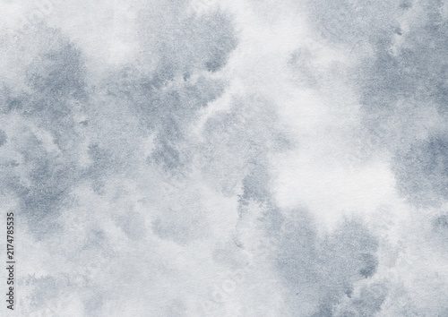 Moody blue gray watercolor texture with dramatic cloudy washes and soft paper grain. Atmospheric abstract background for editorial design, posters, branding and creative projects.