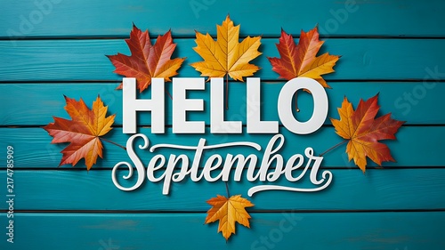 Hello september autumn greeting with colorful fall leaves on wooden background