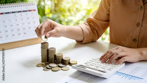 Growing Savings and Financial Planning, Stacking Coins with Calendar and Calculator