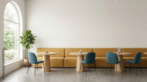 A white cafe interior with a blank wall and yellow couch seating