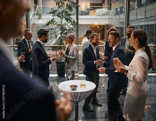 Blurred shot of business people at a party in an office center.