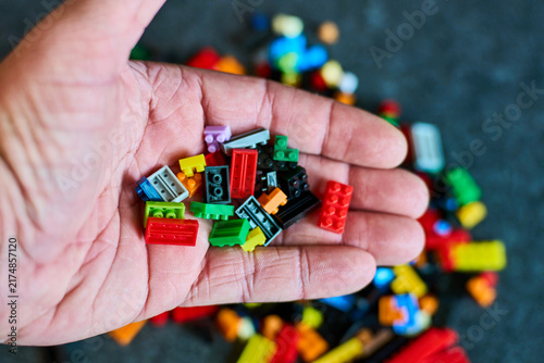 Hand Holding Colorful Building Blocks