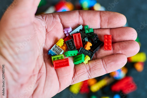 Hand Holding Diverse Bricks - Creative Play Concept