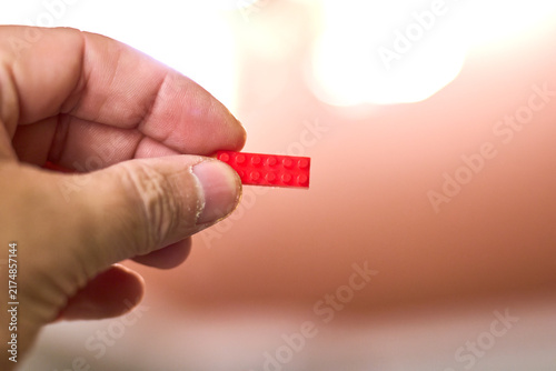 Hand Holding Red Brick - Creative Concept