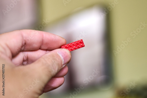 Close-up of Red Brick in Hand - Construction Concept